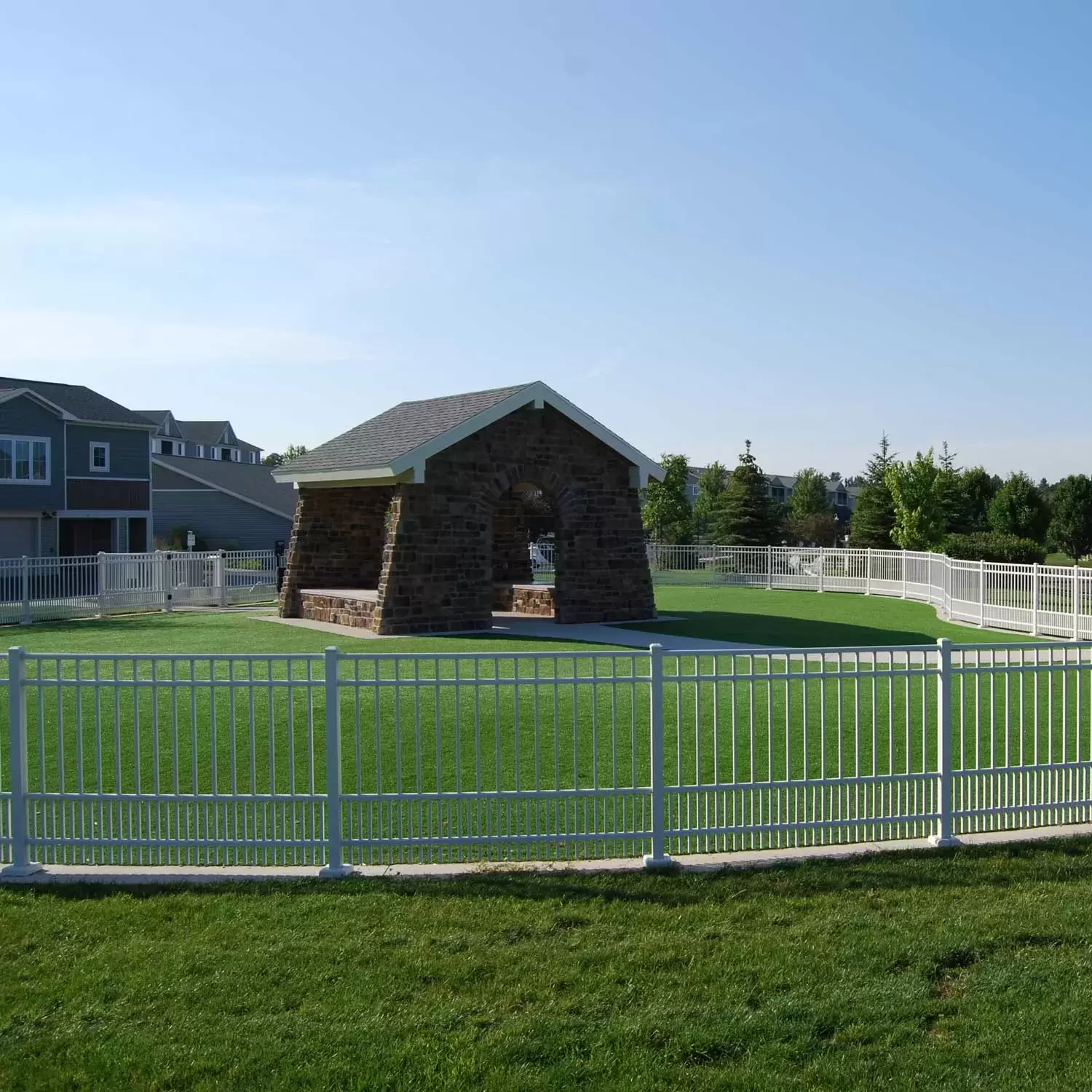 The Bark Park, a fenced grassy area with a covered patio.