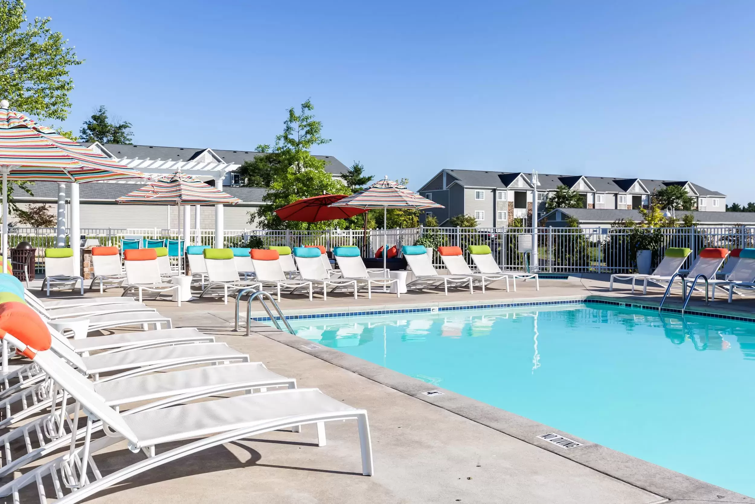 Lounge chairs surround the pool at Liv Arbors Apartments.