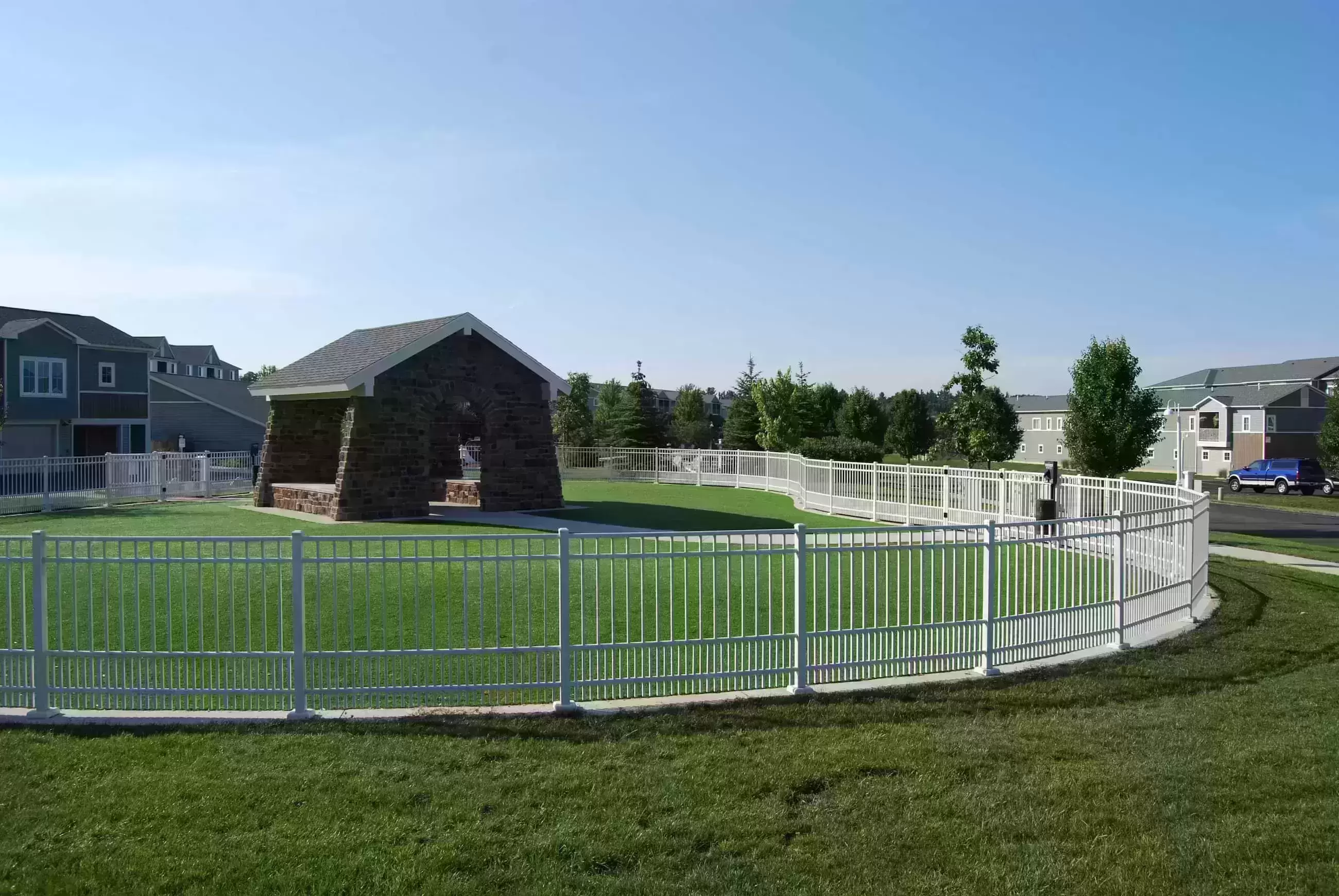 The Bark Park, a fenced grassy area with a covered patio.